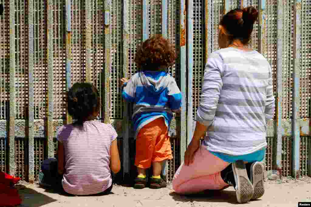 A family commemorates Mother&#39;s Day on the Mexican side of the U.S.-Mexico border in Tijuana, Mexico, May 13, 2017.