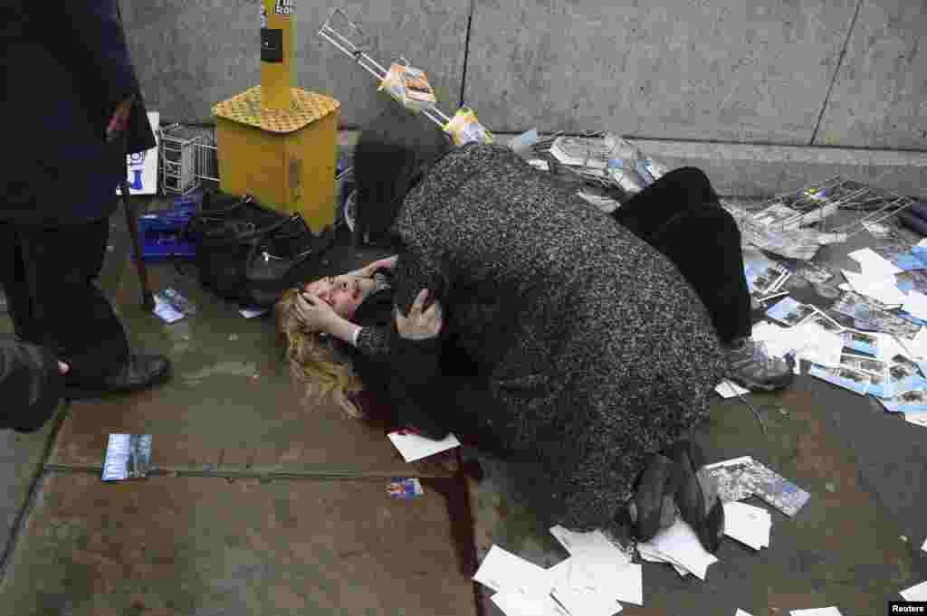A woman lies injured after a shooting incident on Westminster Bridge in London.