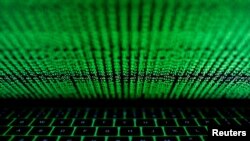 FILE PHOTO: A computer keyboard lit by a displayed cyber code is seen in this illustration picture
