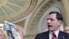Sen. John Barrasso [C] quotes a USA Today article about gas prices as he and Sen. Lamar Alexander [L] and Senate Republican leader Mitch McConnell [R] speak to reporters, at the Capitol in Washington, D.C., May 17, 2011