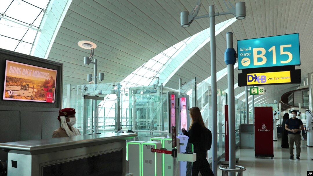 A woman enters the face and iris-recognition gate to board a plane, during a media tour at Dubai Airport, in the United Arab Emirates, March 7, 2021. 