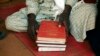 FILE - A Muslim man holds copies of the Koran at the central mosque in Yaloke, north of Bangui, Central African Republic.