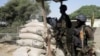 FILE - Cameroon special forces personnel stand guard on the Elbeid bridge in Fotokol, Feb. 17, 2015.