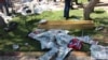 The body of a victim, covered by newspapers, lies next to a coffin after an explosion in Suruc in the southeastern Sanliurfa province, Turkey, July 20, 2015. 