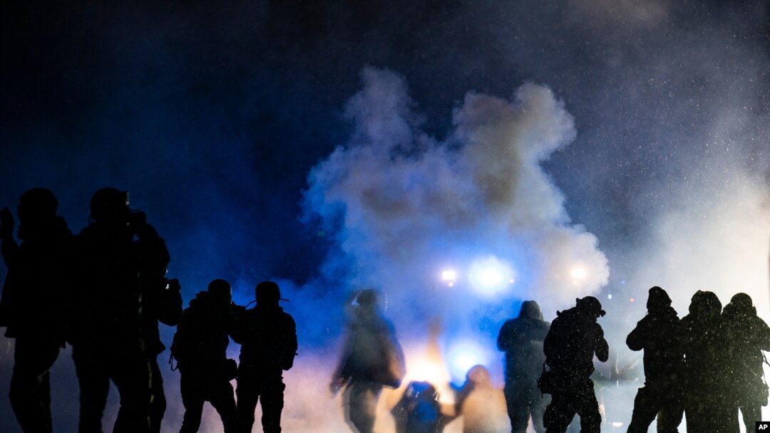 Authorities fire gas munitions at demonstrators gathered outside the Brooklyn Center Police Department to protest the shooting death of Daunte Wright, late April 13, 2021, in Brooklyn Center, Minn. 