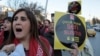 A woman holds a placard as thousands of members of Turkey's main opposition Republican People's Party march to the parliament in Ankara, Turkey, Nov. 22, 2016. 