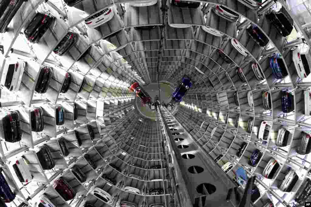 Volkswagen cars are lifted inside a delivery tower of the company in Wolfsburg, Germany.