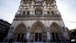 People stand outside Notre Dame cathedral in Paris on Nov. 29 2024. 