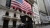 A man wearing a mask walks by the New York Stock Exchange, March 17, 2020. 