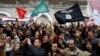Protesters shout slogans and wave flags during a demonstration in support of the ruling party Ennahda in Tunis February 9, 2013.