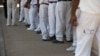 FILE - Prisoners are seen standing in a crowded lunch line.