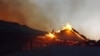 The Garissa Halgan Quran House Resort Hotel is engulfed in flames after Kenyan security personnel, according to residents, swept into the predominantly ethnic-Somali town beating people and burning property, northern Kenya, Nov. 19, 2012.