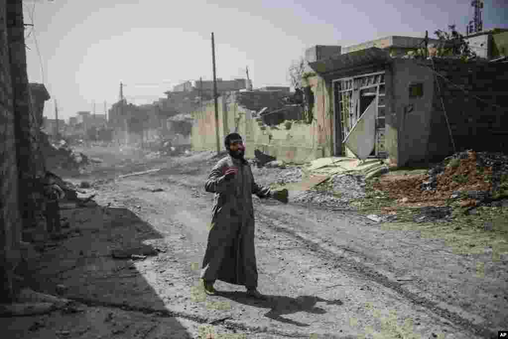 A Mosul residents shouts for help after he fled his home in west Mosul as fighting between Iraqi forces and the Islamic State group continues.