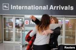FILE - Mahnaz Kanani Zadeh, right, is greeted by her niece Negin after traveling to the U.S. from Iran following a federal court's temporary stay of U.S. President Donald Trump's executive order travel ban, at Logan Airport in Boston, Massachusetts, Feb.