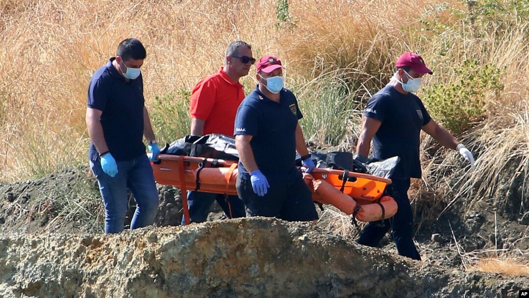 A crew carries what are believed to be remains of a 6-year-old girl, near Xiliatos, Cyprus, June 12, 2019. Cyprus authorities believe the girl was the victim of a confessed serial killer, a Cyprus army captain.
