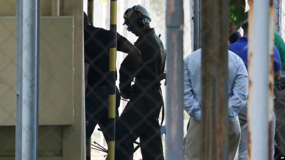 U.S. Marine Pfc Joseph Scott Pemberton, a suspect in the killing of a transgender Filipino woman, is escorted to his detention inside the compound of the Camp Aguinaldo military headquarters in suburban Quezon city, north of Manila, Philippines, Oct. 22, 2014.