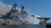 This U.S. Navy photo released July 13, 2020, shows sailors and federal firefighters battling a blaze onboard the amphibious assault ship USS Bonhomme Richard at Naval Base San Diego, California, July 12, 2020. (Christina Ross, U.S. Navy via AFP) 