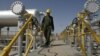 Iranian oil technician Majid Afshari makes his way to the oil separator facilities in Iran's Azadegan oil field southwest of Tehran, Iran, April 15, 2008 (file photo).
