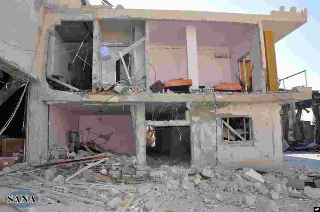 A damaged building of al-Ikbariya TV is seen after it was attacked by gunmen, in the town of Drousha, about 20 kilometers (14 miles) south of Damascus, June 27, 2012. (photo released by the Syrian official news agency, SANA)