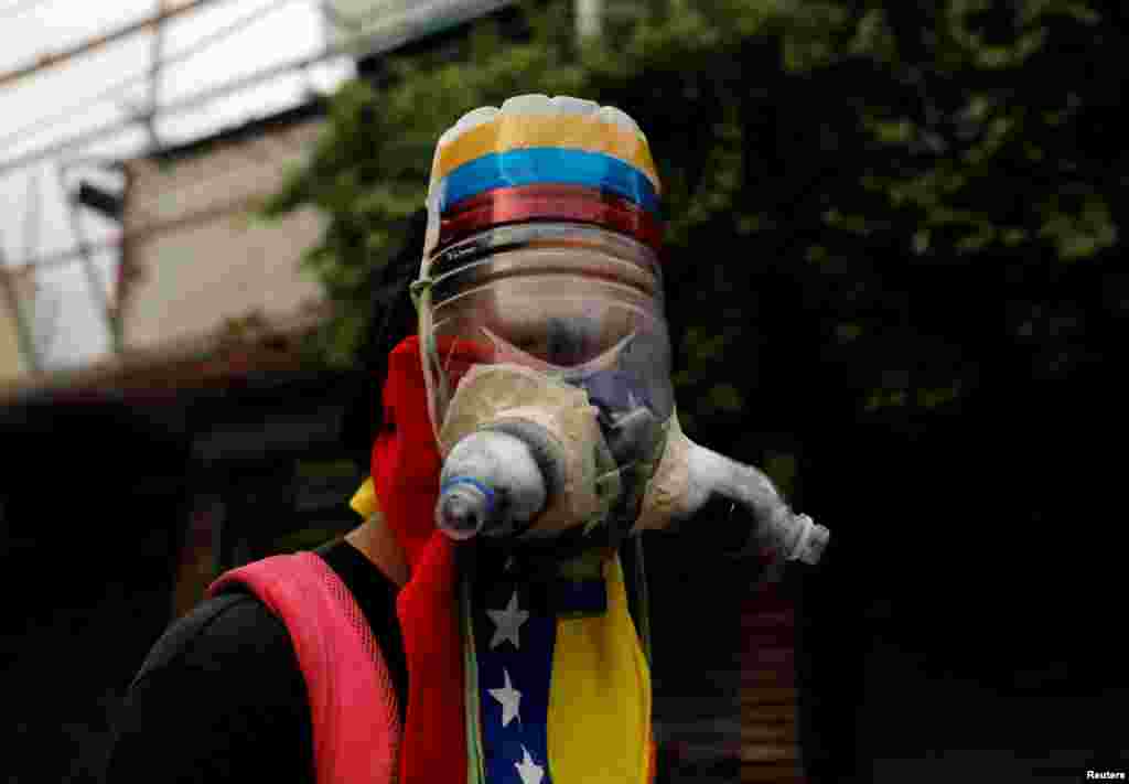 A demonstrator wears a homemade gas mask during a rally against Venezuela&#39;s President Nicolas Maduro in Caracas, May 1, 2017.
