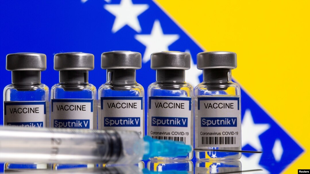 FILE - Vials labelled "Sputnik V coronavirus disease (COVID-19) vaccine" and a syringe are seen in front of a displayed Bosnian flag in this illustration picture taken March 17, 2021.
