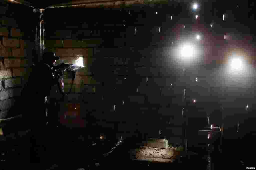 A sniper of the Iraqi Federal Police takes his position at a destroyed building at Bab al Jadid district in the old city of Mosul, Iraq.