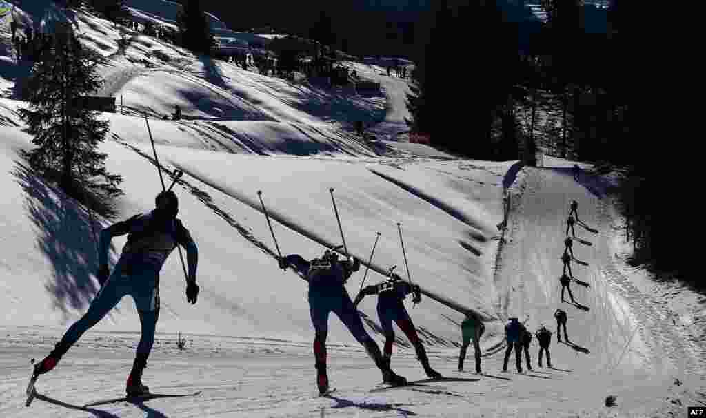 Biathletes compete during the men's 15 km mass start race at the Biathlon World Championships in Hochfilzen, Austria.