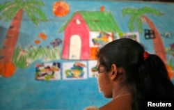 FILE - A 16-year-old girl stands inside a protection home on the outskirts of New Delhi. She was working as a maid and was later rescued by Bachpan Bachao Andolan (Save the Childhood Movement), a charity that rescues victims of bonded labor.