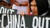 FILE - Protesters hold placards during a rally outside the Chinese Consulate in Manila to protest China's artificial island-building at the disputed islands, reefs and shoals off South China Sea.