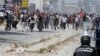 Supporters of Islamist group Ansar al-Sharia clash with riot police at Hai al-Tadamon in Tunis, May 19, 2013. 