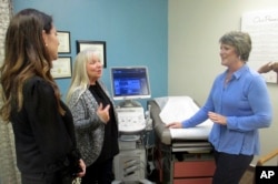 FILE - Staff members talk at a crisis pregnancy center in Grilroy, Calif., Feb. 8, 2018.
