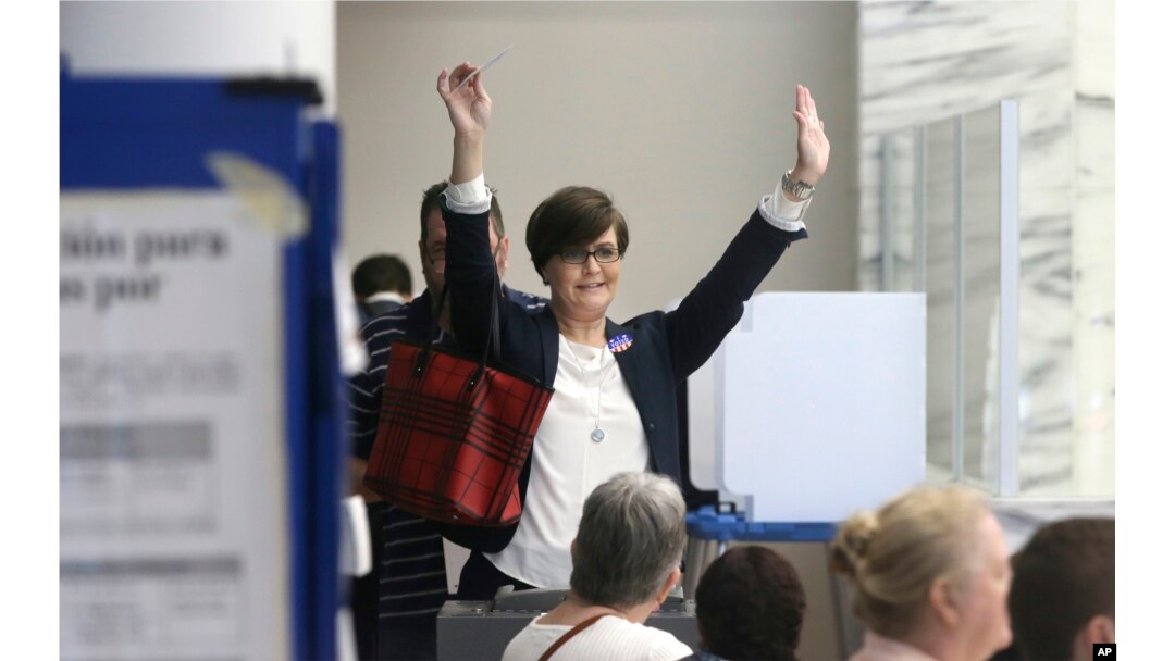 Leah Schier throws up her arms after casting her ballot in Dallas, Nov. 8, 2016. "I was so exited to cast my vote for a woman," she said.