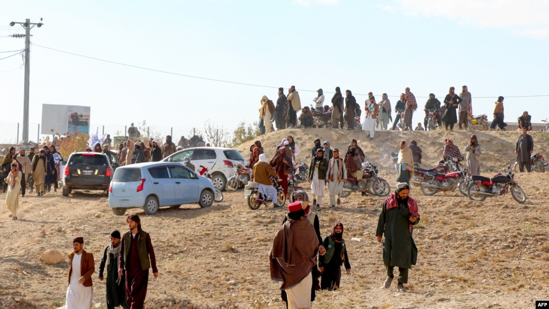 FILE - Afghan men leave after watching the public execution of a man by the Taliban at a football stadium in Gardez, in Paktia province, on Nov. 13, 2024. Taliban authorities defend their practice of public executions and public floggings, despite global outcry. 