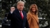 FILE - U.S. President Donald Trump walks with first lady Melania Trump while departing for Palm Beach, Fla., from the White House in Washington, Feb. 1, 2019.