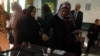 A woman dips her finger in ink after casting her vote in a referendum on Egypt's new constitution, at a school used as a polling station in Alexandria, Egypt, December 15, 2012.
