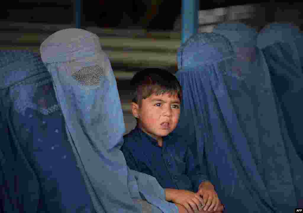Afghan refugee families wait to be registered at the United Nations High Commissioner for Refugees (UNHCR) repatriation center on the outskirts of Peshawar.