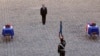 French President Francois Hollande pays his respects in front of the two flag-draped coffins bearing the French soldiers who died last week in the Central African Republic, during a ceremony at the Invalides, in Paris, Dec. 16, 2013. 