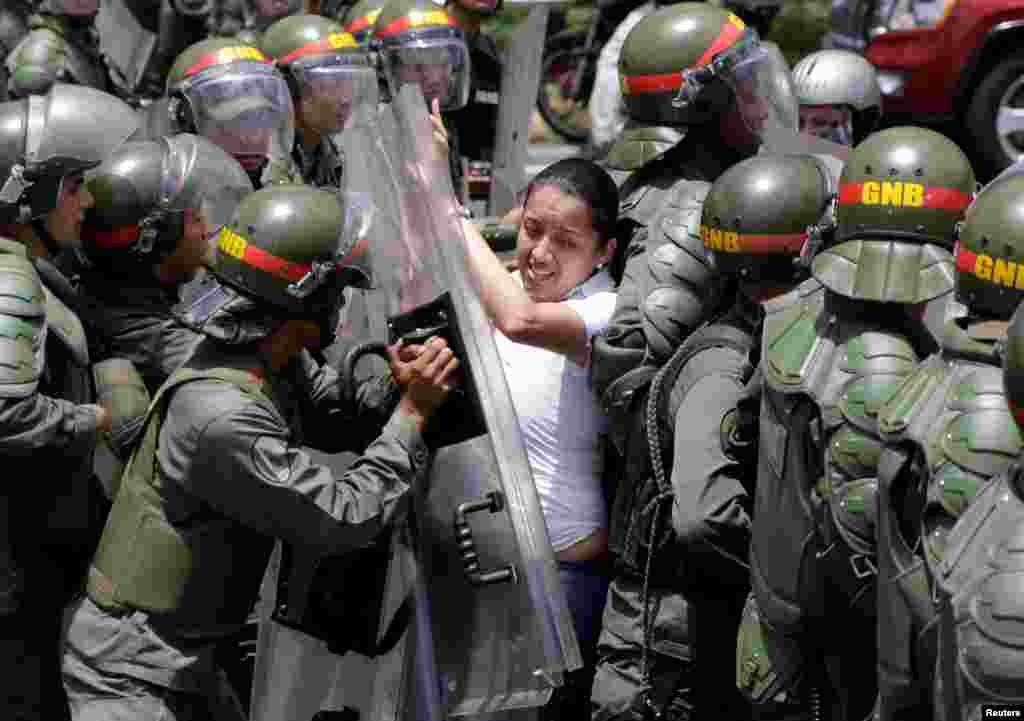 Gaby Arellano, deputy of the Venezuelan coalition of opposition parties (MUD), clashes with national guards during a rally against President Nicolas Maduro's government in Caracas, April 1, 2017.