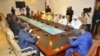 Burkina Faso President Blaire Compaore (R), the top mediator in Mali's crisis, and his delegation meet at the presidential palace in Ouagadougou with rebel leaders (R) from the Islamist Ansar Dine, June 1, 2012.