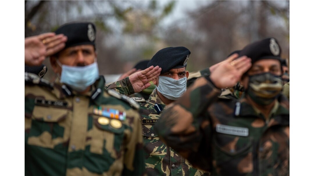 FILE - India Border Security Force soldiers salute as they pay respect to their colleague killed during a recent clash with Pakistani soldiers in Kashmir, Nov. 15, 2020.