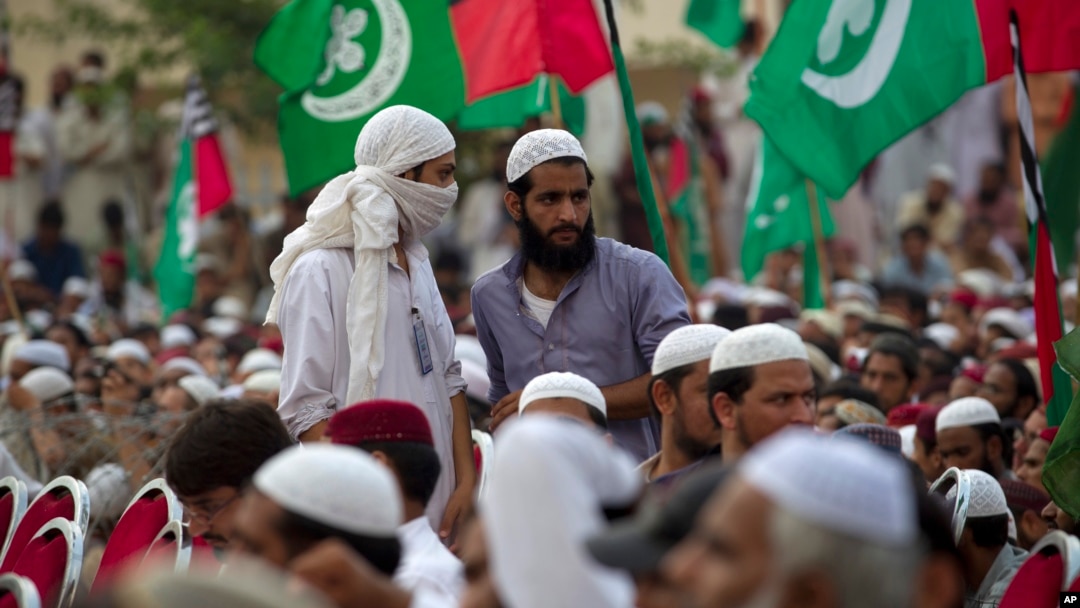 FILE - Supporters of banned sectarian group Sipah-e-Sahaba listen to their leaders at a gathering in Islamabad, Pakistan, Oct. 4, 2013. Pakistan's DAWN newspaper says that 41 of the 64 extremist organizations banned by the government operate freely online
