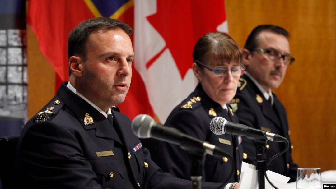 From left, James Malizia and Jennifer Strachan, both Royal Canadian Mounted Police officials, and Deputy Commissioner Scott Tod of the Ontario Provincial Police talk to reporters in Ottawa after announcing terror-related charges against three men, Feb. 3, 2015. 