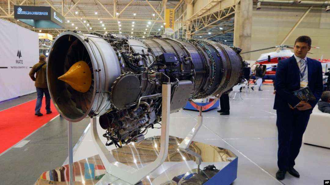 FILE - A visitor looks at a turbofan AI-322F engine for combat trainers and light combat aircraft made by Ukraine's Motor Sich manufacturer at an international weapons exhibition in Kyiv, Ukraine, Oct. 9, 2018. 