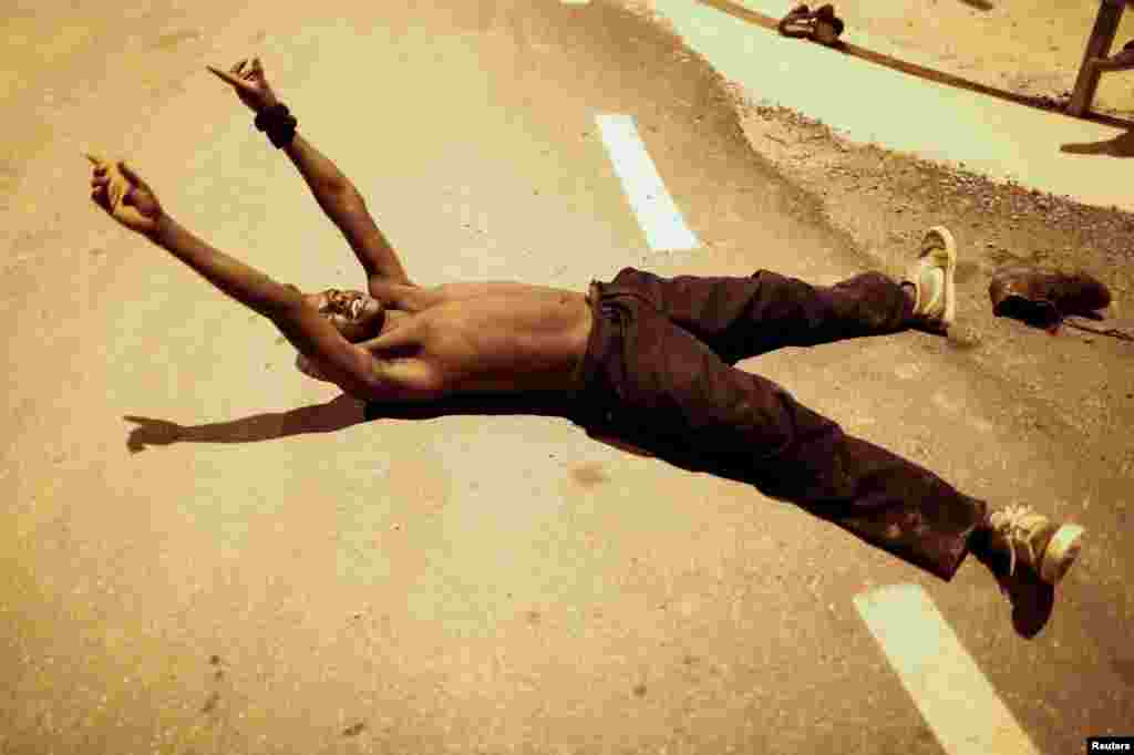 An African migrant reacts as he arrives at the CETI, the short-stay immigrant center, after crossing the border from Morocco to Spain's North African enclave of Ceuta, Spain.