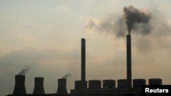 FILE - Smoke rises from the Duvha coal-based power station owned by state power utility Eskom, in Mpumalanga province, South Africa, Feb. 18, 2020. 