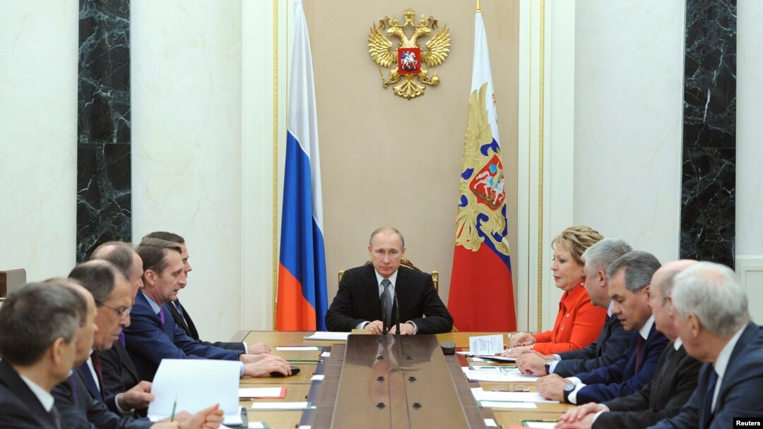 Russian President Vladimir Putin (C) chairs a meeting with members of the Security Council at the Kremlin in Moscow, Mar. 6, 2015. Russia is seen as using propaganda and money to, as one analyst put it, "divide and split Europe." 