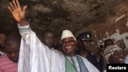 Sierra Leone's incumbent President Ernest Bai Koroma waves to supporters after voting in the capital, Freetown, November 17, 2012.