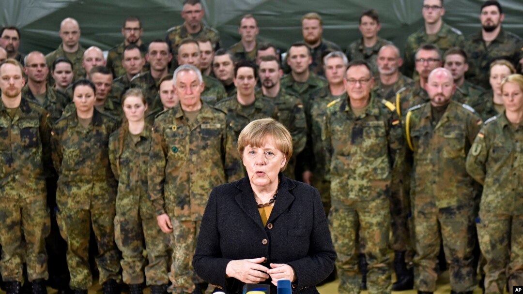 FILE - German chancellor Angela Merkel visits soldiers with the German Army medical service in Leer, northern Germany, Dec. 7, 2015. Germany's parliament voted last week to send military support in the fight against Islamic State militants in Syria. 