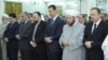 Syria's President Bashar al-Assad (3nd R ) attends Eid Al Fitr prayers at al-Hamad mosque in Damascus, August 19, 2012.