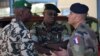 A French army officer (R) talks to his Malian and Senegalese army counterparts outside where a meeting is taking place for the intervention force provided by the ECOWAS grouping of West African states, in Bamako January 15, 2013.